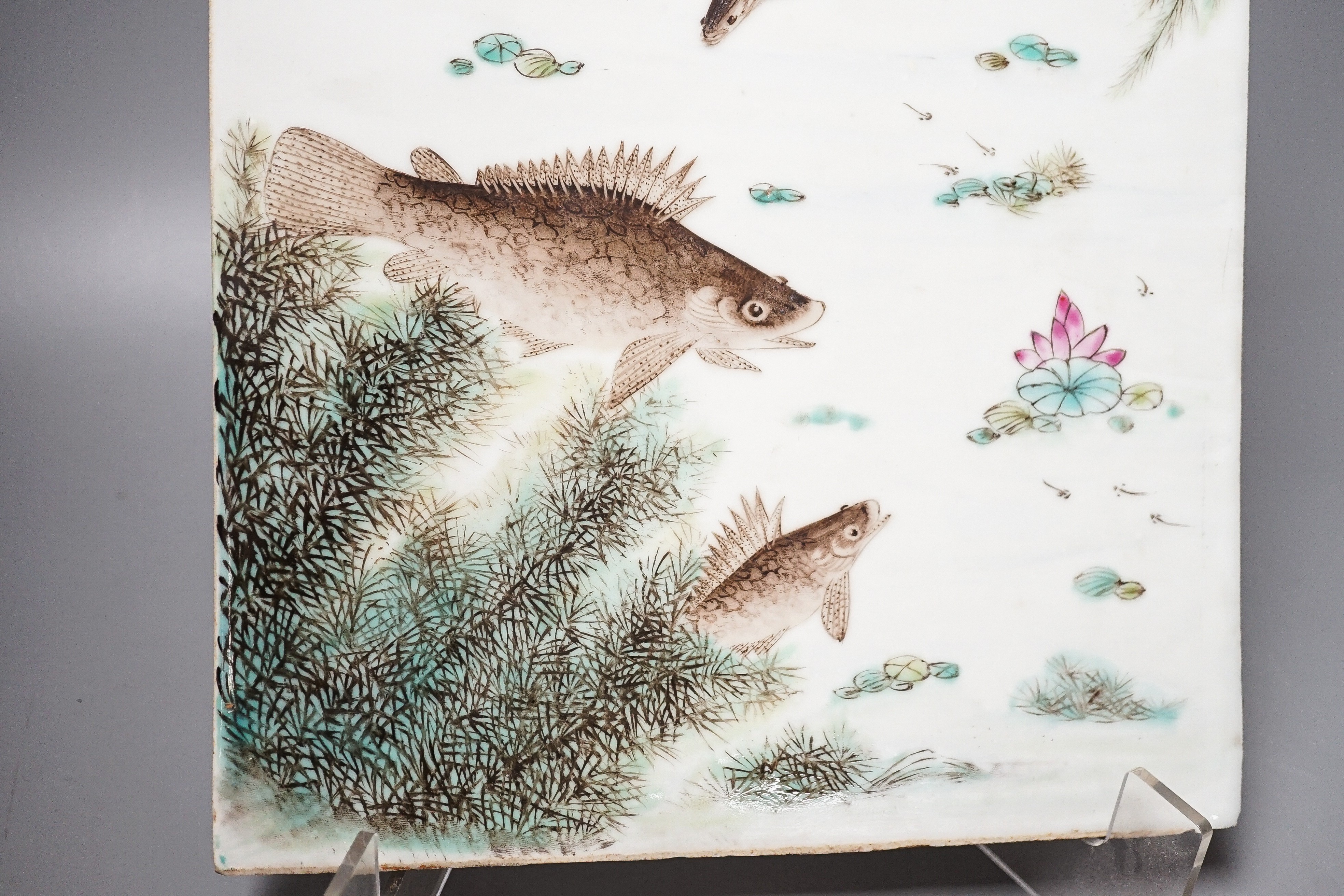 A Chinese famille rose porcelain rectangular plaque, Republic period (1912-49), painted with fish in a pond amid weed and inscribed upper left 36.5x25.5cm